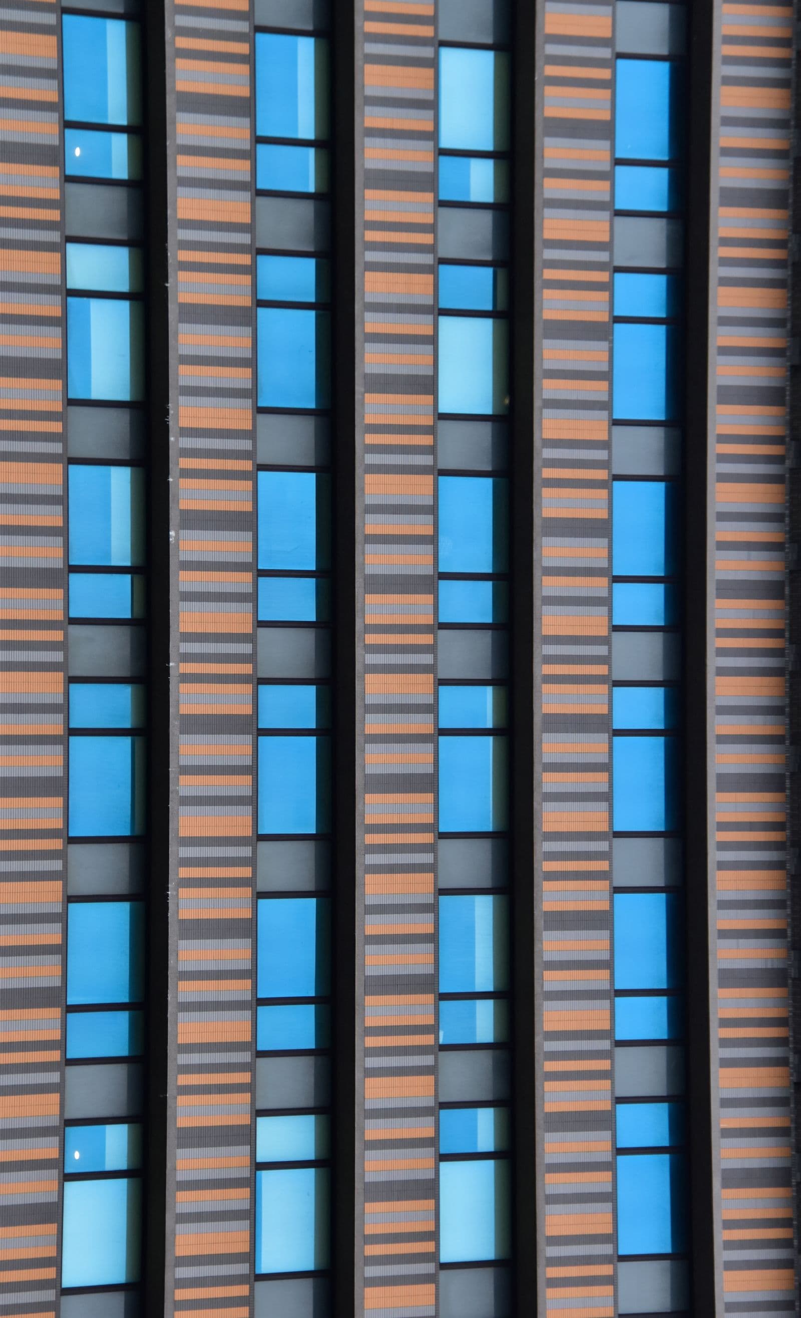 A tall facade of repeating window bands